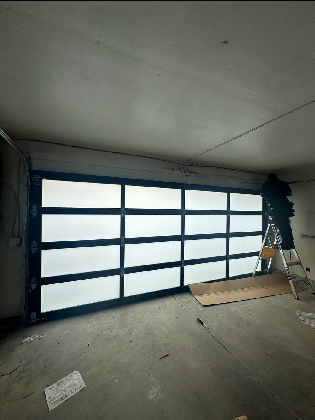 Full-view glass and aluminum garage door installation