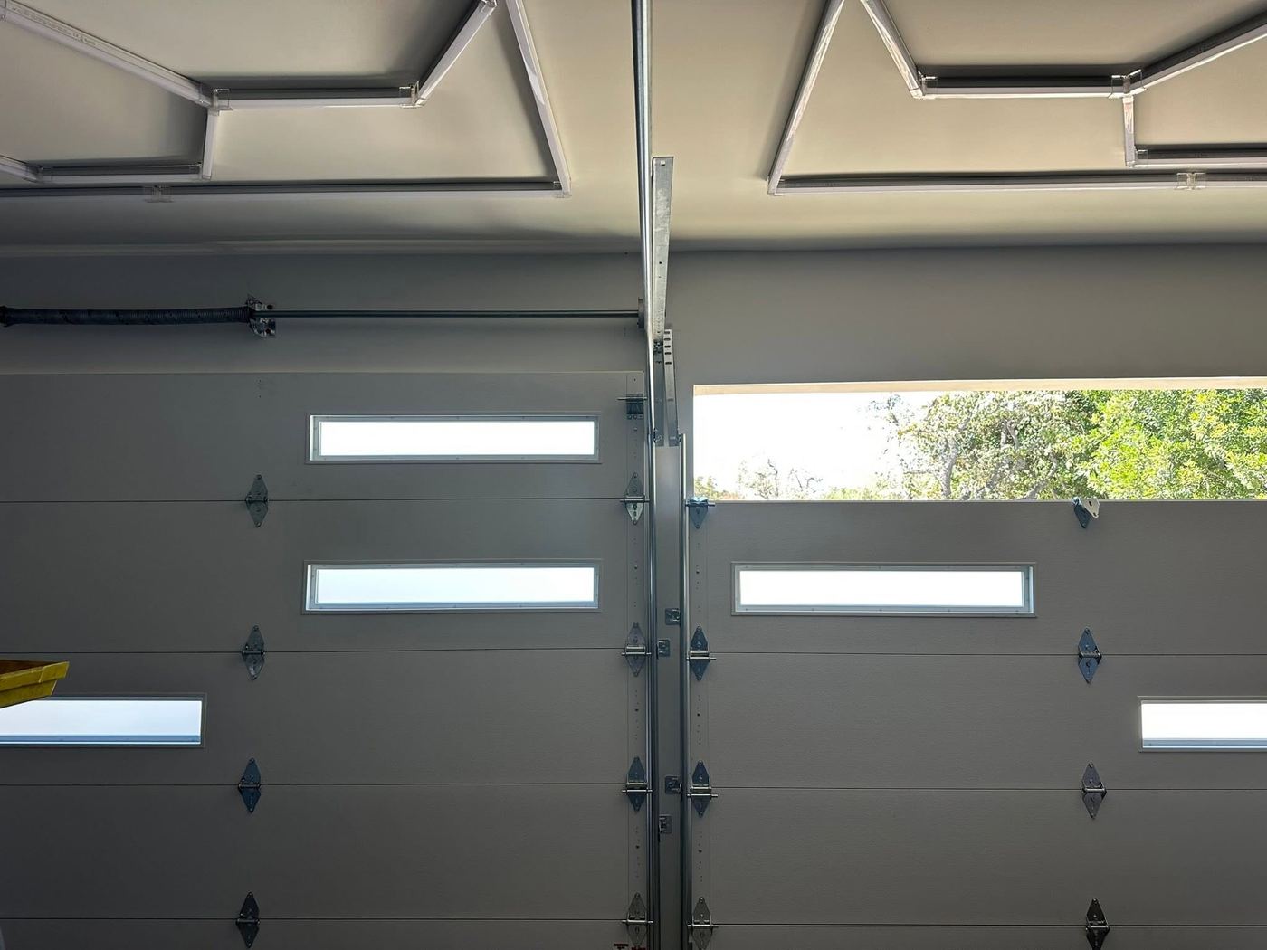 Close-up of garage door window panels and hardware