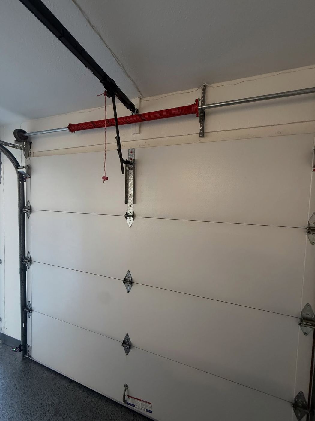 Newly installed torsion spring bracket