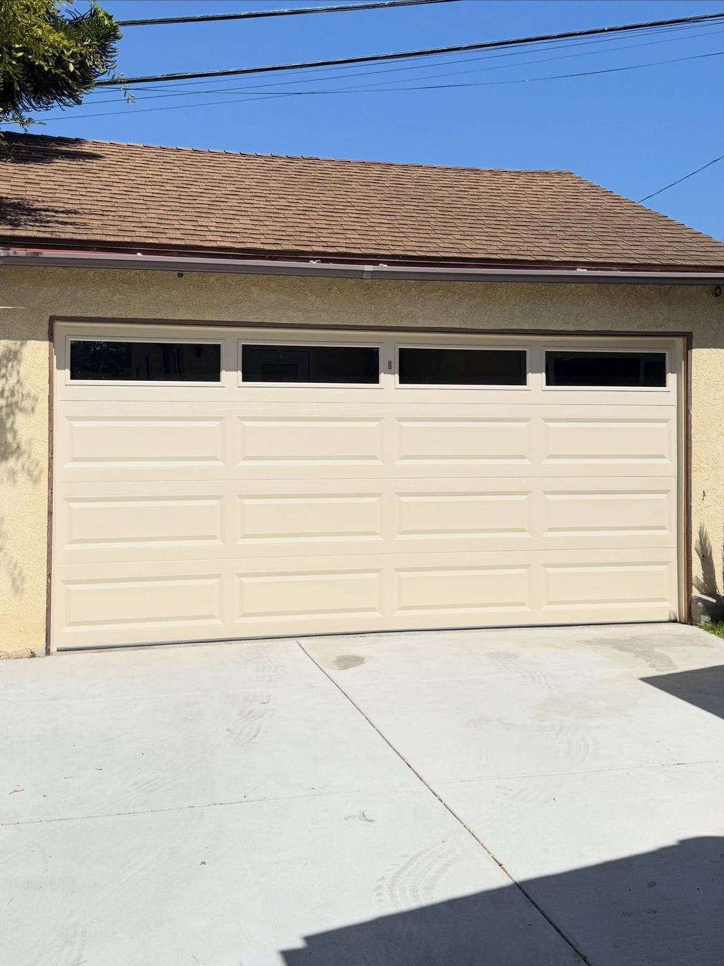 Garage door opener motor unit mounted to the ceiling with safety bracket