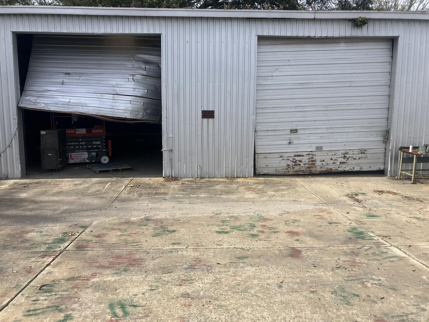 Storm and impact damaged garage door panel needing replacement